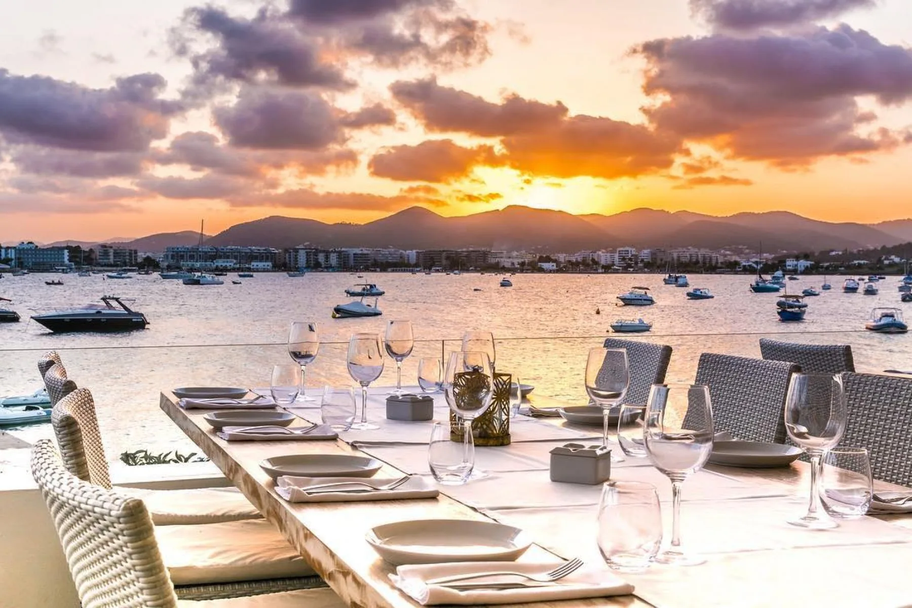 Waterfront dinner table overlooking an Ibiza sunset