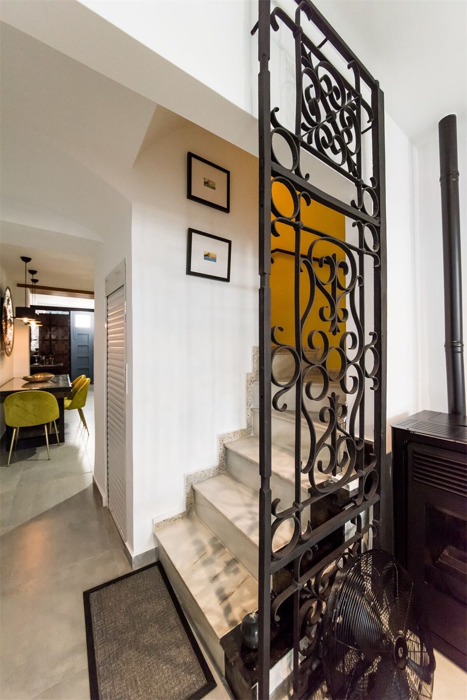 Casa Toro interior stairs with decorative ironwork and dining room view